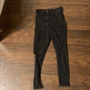 Petite Black ripped high rise jeans.